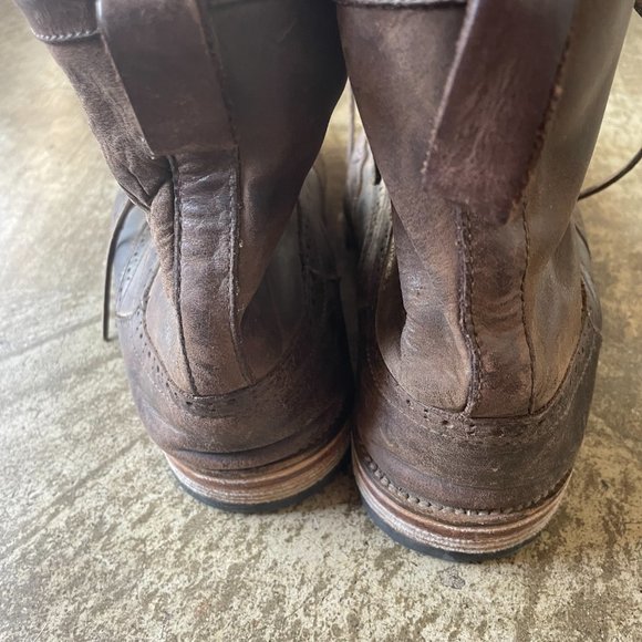 Wing tipped brown leather boots
